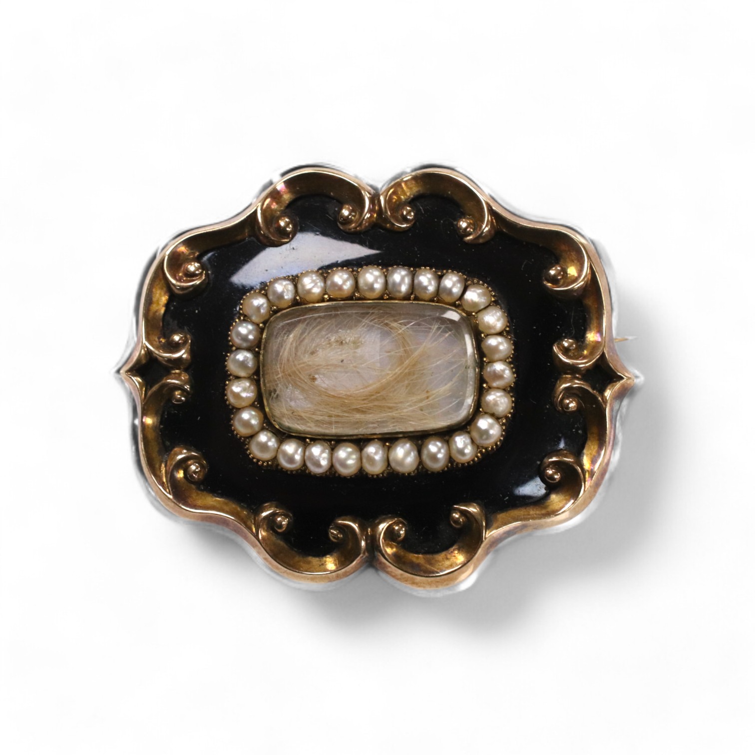 A late Victorian yellow metal, black enamel and split pearl set mourning brooch, with engraved inscription 'Sarah Appleyard, born 16th December 1804, died 12th Jan 1886', 46mm, with hair below a glazed panel. Condition -